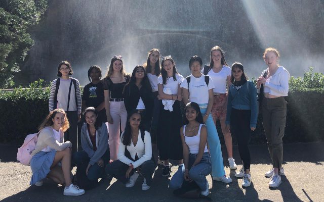 Students in Barcelona standing infront of a waterfall in a park.