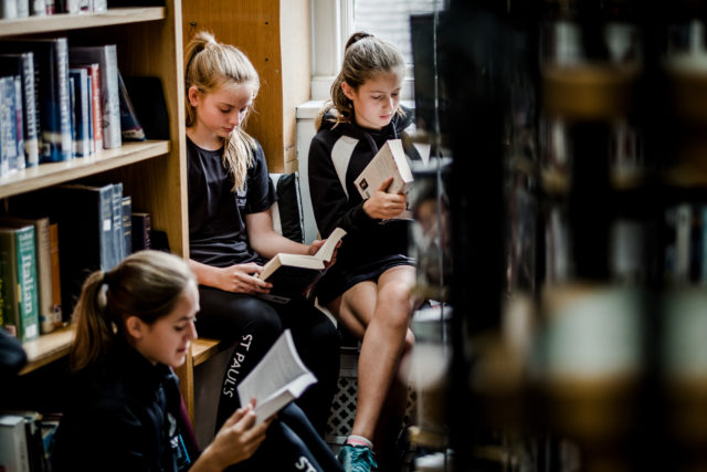 Students reading books in the library.