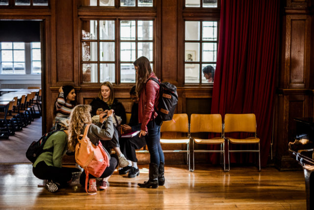 Students sitting and talking in the Great Hall.