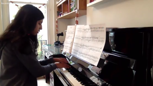 Student playing piano at home during lockdown, broadcast to the school as part of the Platform Concert in January 2021