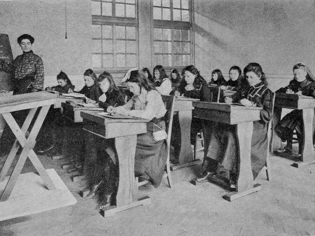 First students studying at their desks in a classroom in 1904.