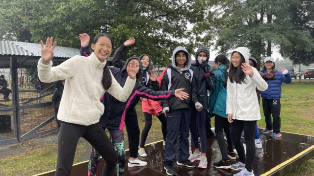 Students smiling, enjoying their trip together outdoors.