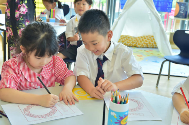 Boy and girl in classroom at SPGS International school Chengdu, China.