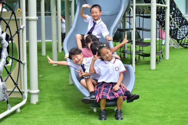 Children playing on slide at SPGS International school in Chengdu, China.