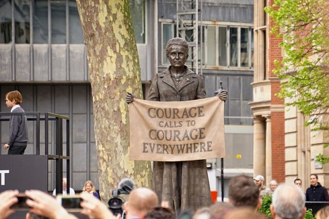 Statue of Millicent Fawcett with banner reading 'Courage calls to courage everywhere'