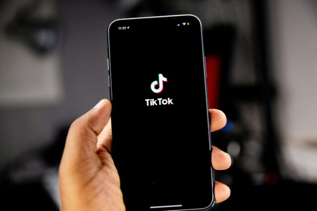 Phone being held with TikTok app open